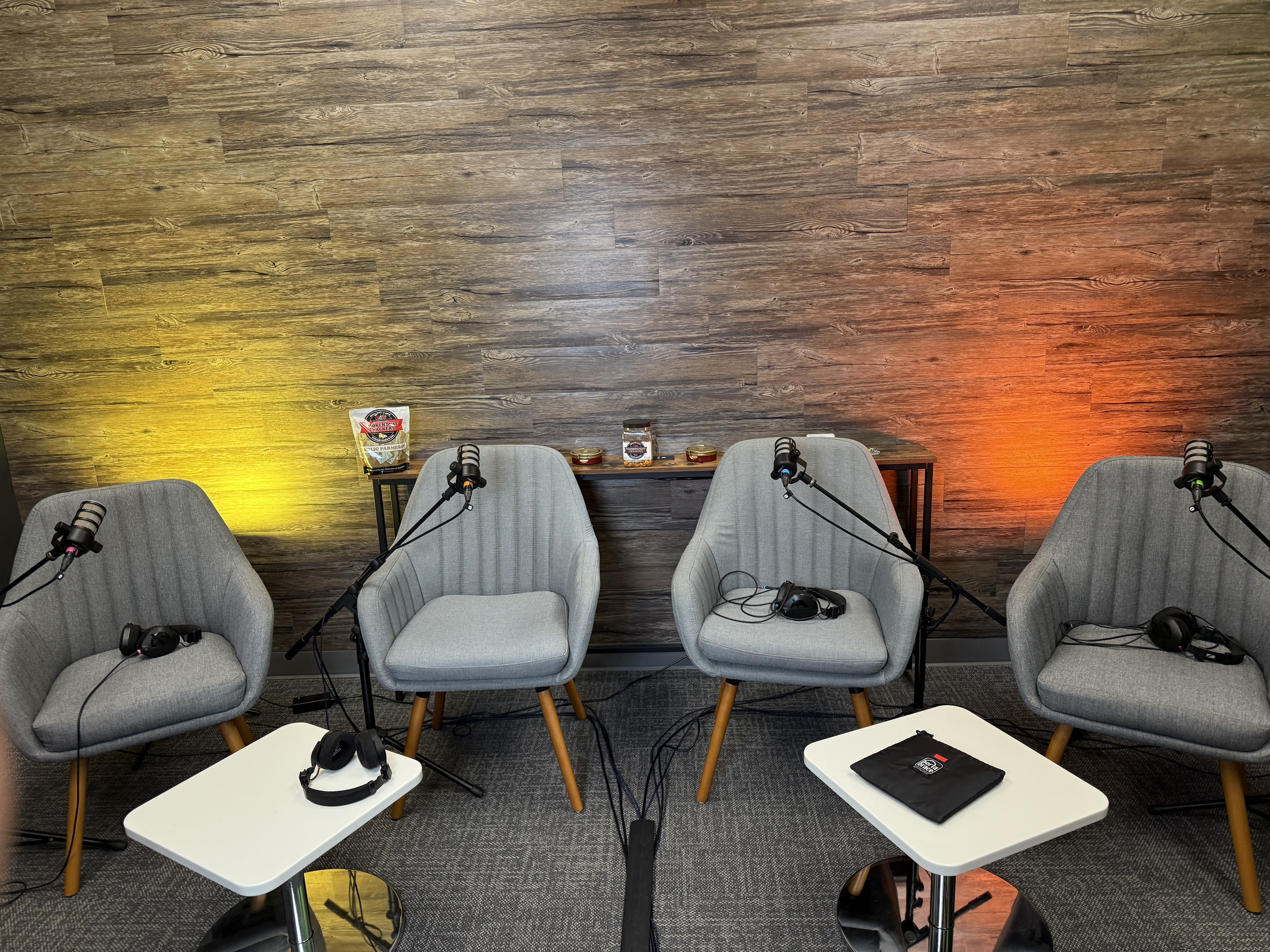 Four-chair lounge recording setup with warm lighting