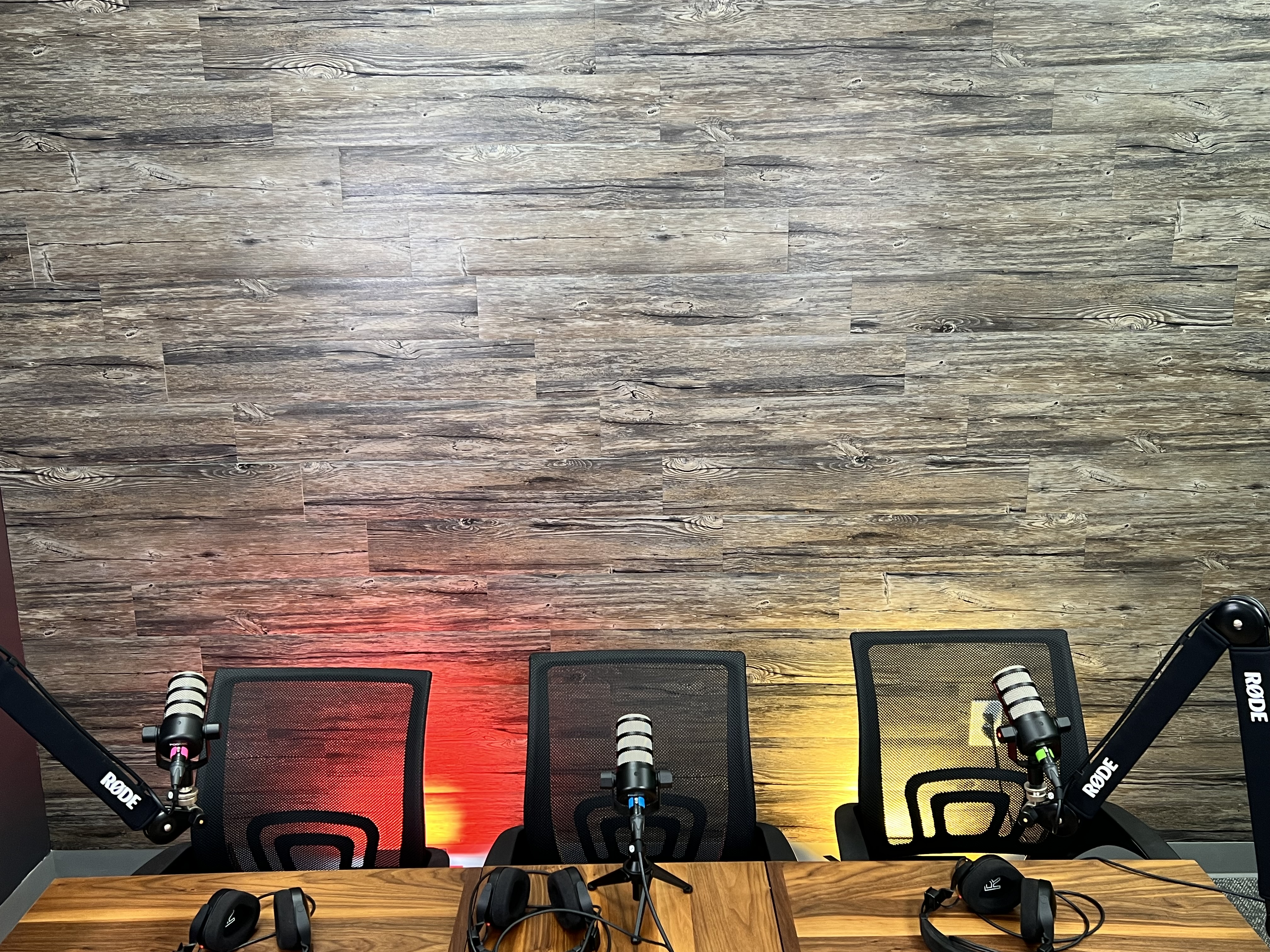 Three-seat podcast desk with microphones, overhead view